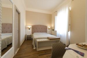 Een bed of bedden in een kamer bij Albergo Battelli