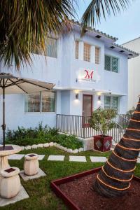 a house that has a lawn chair in front of it at M Boutique Hotel in Miami Beach