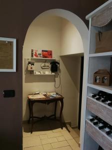 a room with a table and a shelf with wine bottles at B&B Cascina Barolo in Turin