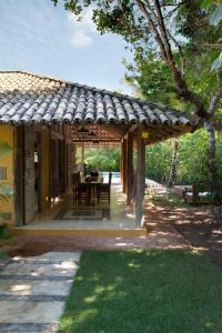 a wooden pergola with a table in a yard at Casas da Vila in Trancoso