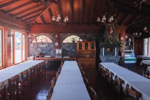 a dining room with long tables and chairs in it at Rural de Sanroque in Santana