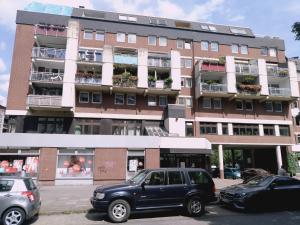 a large building with cars parked in front of it at Burhan in Hamburg