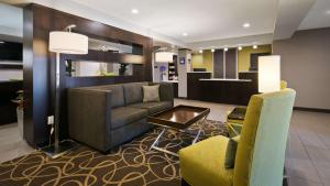 a lobby with a couch and chairs and a table at Best Western Harvest Inn & Suites in Grand Forks
