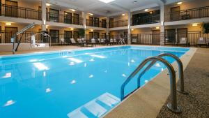 a large pool in a hotel with blue water at Best Western Harvest Inn & Suites in Grand Forks