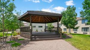 a wooden gazebo in a yard in front of a building at Best Western Ramkota Hotel in Rapid City