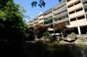 a building next to a river next to a building at Park Place Condos in Gatlinburg