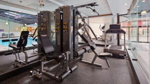 a gym with cardio equipment and a swimming pool at Best Western Plus Ottawa Kanata Hotel and Conference Centre in Ottawa