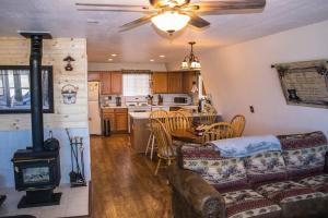 a living room with a couch and a stove at Aspen Meadow Cabin in Duck Creek Village