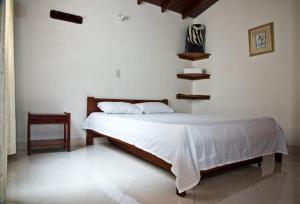 En eller flere senge i et værelse på Hotel Lagos de Guatape