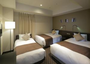 Postel nebo postele na pokoji v ubytování Akihabara Washington Hotel