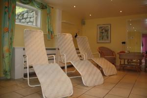 a group of chairs sitting in a room at Pension Sursilva in Gargellen