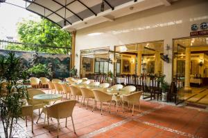 a group of tables and chairs in a building at Thuy Anh Hotel in Ninh Binh