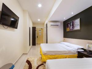 Postel nebo postele na pokoji v ubytování One Avenue Hotel
