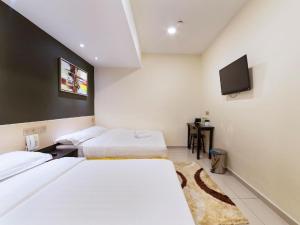 Postel nebo postele na pokoji v ubytování One Avenue Hotel