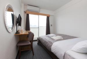 Voodi või voodid majutusasutuse Global Resort Miyajima View toas