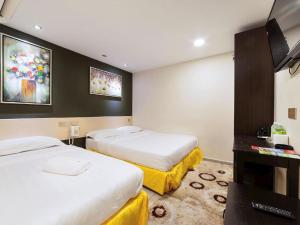 TV a/nebo společenská místnost v ubytování One Avenue Hotel