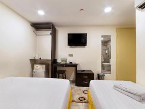 Postel nebo postele na pokoji v ubytování One Avenue Hotel
