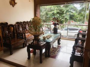 a living room with a table and chairs and a window at Minh Hoang Hotel & Homestay in Cao Bằng