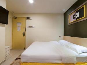 Postel nebo postele na pokoji v ubytování One Avenue Hotel