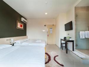 Postel nebo postele na pokoji v ubytování One Avenue Hotel