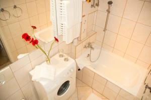 a bathroom with a washing machine with flowers in it at Apartament - Old Town Studio in Gdańsk