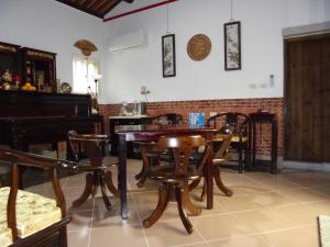 a room with chairs and a table and a piano at 任我行民宿 in Jincheng