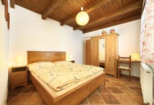 a bedroom with a bed and a desk and a chair at Pension Adam in Horní Planá