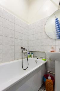 un bagno bianco con vasca e lavandino di Apartment on Ploshchad Lenina 12/2 ad Astrakhan