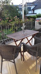 a wooden table and two chairs and a table and chairs at Ferienwohnung am Theo Carlen Platz in Ormesheim