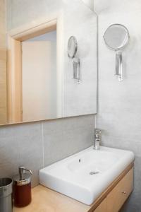 a bathroom with a white sink and a mirror at Sol y Mar in Órmos