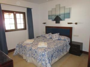 a bedroom with a bed with two towels on it at Casa La Barca in Playa Honda +20 photos