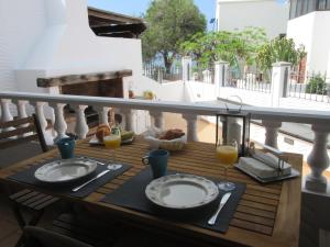 a table with two plates of food and glasses of orange juice at Casa La Barca in Playa Honda