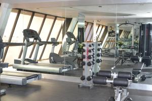 a gym with several tread machines and mirrors at Hotel Royal Reforma in Mexico City