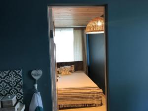 a small bedroom with a bed and a window at Apartment near by sea in Jūrmala