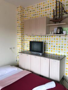 a room with two beds and a tv on a counter at Baan Pak I-Un Hua Hin in Hua Hin