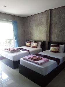Tempat tidur dalam kamar di Real Relax Resort