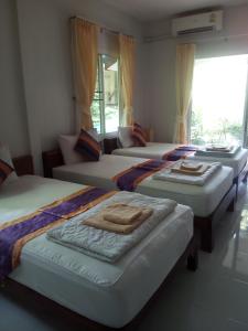 Un grupo de 4 camas en una habitación en Real Relax Resort, en Ao Nang Beach
