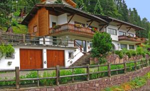 a house with a fence in front of it at Holiday Apartments Costanzi in Ortisei