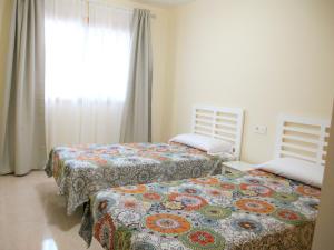 Posteľ alebo postele v izbe v ubytovaní Apartmento La Perla el Medano