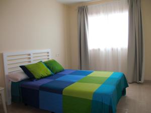 Posteľ alebo postele v izbe v ubytovaní Apartmento La Perla el Medano