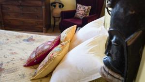 Een bed of bedden in een kamer bij L'Ancienne Auberge