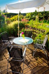 een tafel met stoelen en een parasol op een patio bij Ferienhaus Doris in Dwasieden