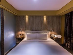Voodi või voodid majutusasutuse inhouse Hotel toas