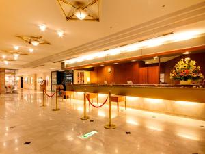 a lobby with a bar with red ropes on the floor at Hotel Pearl City Kobe in Kobe
