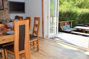 a dining room with a table and a sliding glass door at The Ranch Lodge in Benmore