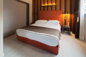 a bedroom with a large bed in a room at Fifty House Cellini in Milan
