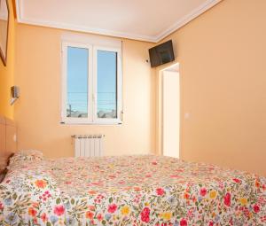 Łóżko lub łóżka w pokoju w obiekcie HOSTAL EUROPA pensión