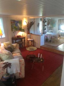 a living room with a couch and a table at Swedish Idyll in Årstad