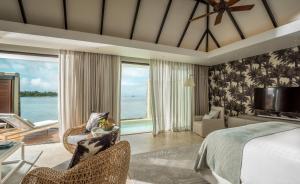 a bedroom with a bed and a view of the ocean at Four Seasons Resort Mauritius at Anahita in Beau Champ