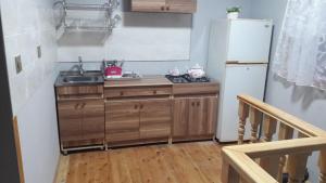 a small kitchen with a sink and a refrigerator at Guesthouse Khazar in old city in Baku